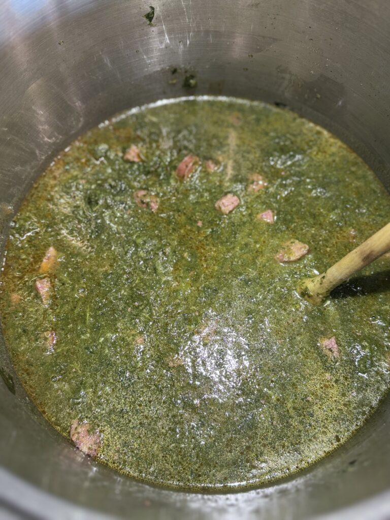 Add greens and roux to pot and cook