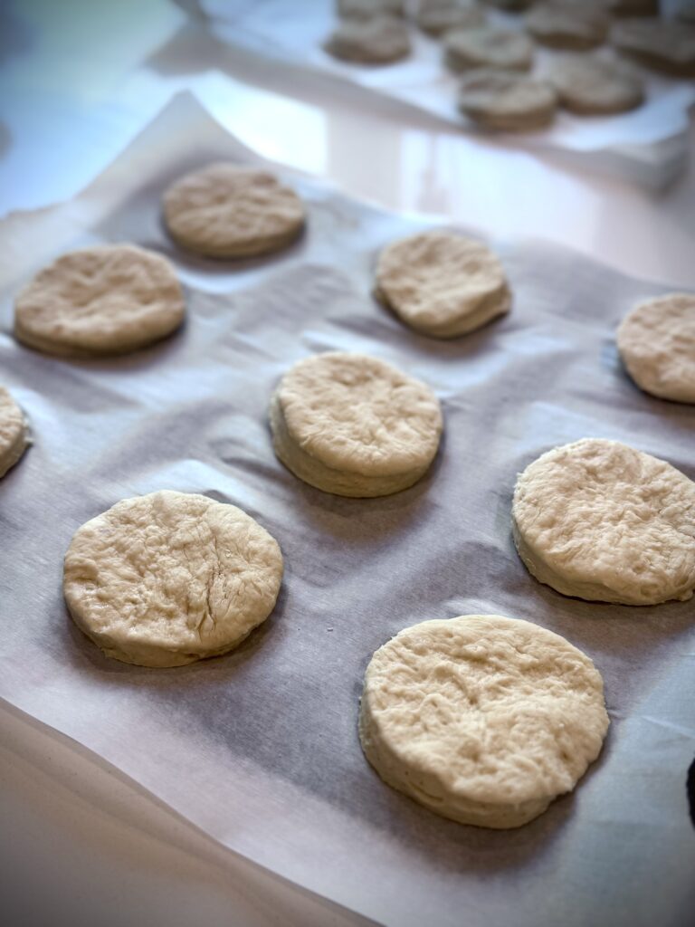 Place the biscuit rounds 1 inch apart on a parchment-lined baking sheet. Gather the scraps, reshape them, and pat them out to a 1/2-inch thickness. Cut out the biscuits as above. Discard any remaining scraps.