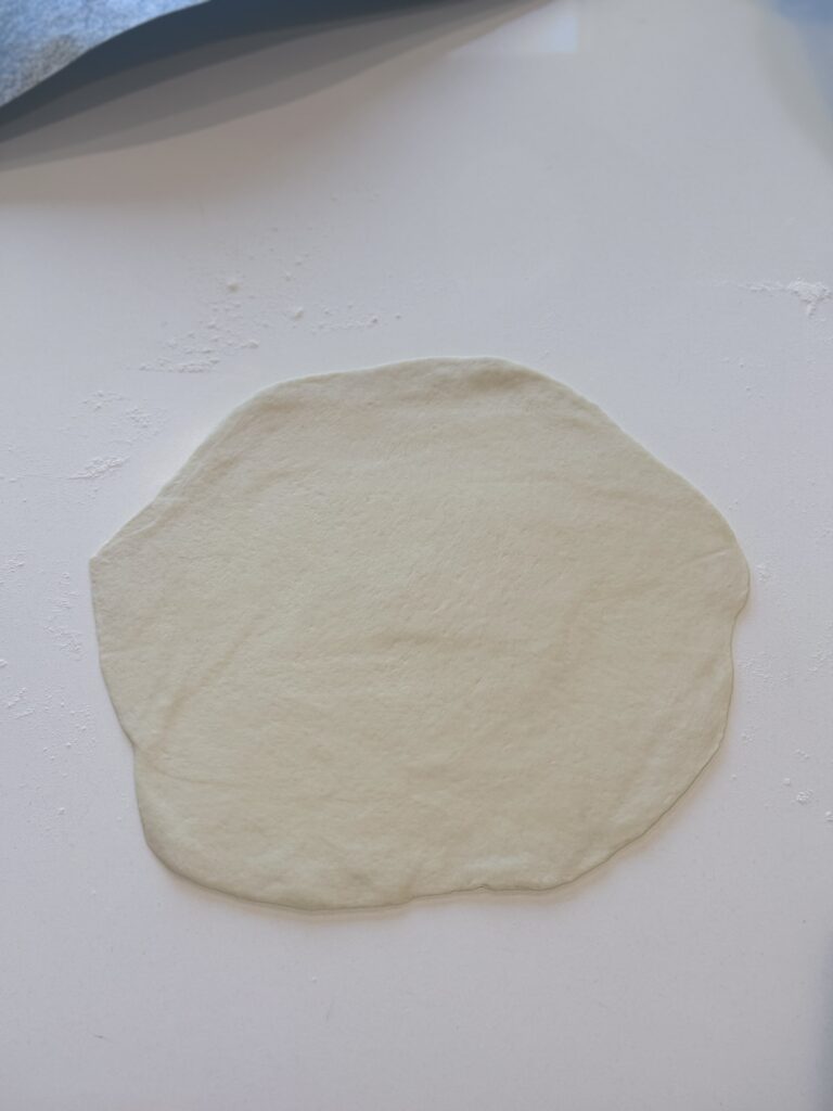 When the dough is ready, portion it into six golf-ball-size pieces. Dust a work surface with flour and roll each piece of dough into a rectangle (or whatever shape you want). If you're not using the dough immediately, wrap each ball individually in plastic and refrigerate until ready.