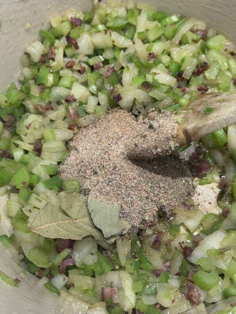 Sprinkle in the seasoning mix and add the minced garlic. Stir constantly for 3 minutes, allowing the spices to bloom and become fragrant.