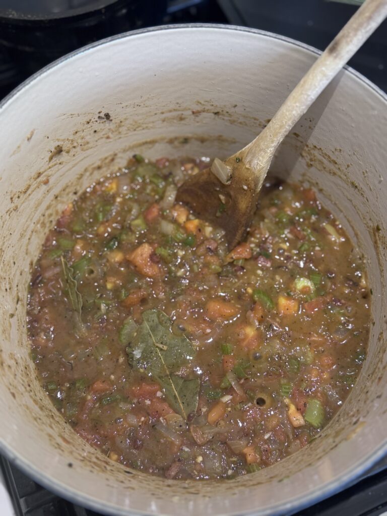 Pour in the seafood or chicken stock and bring the mixture to a boil. Add the chopped green onions and cook for about 2 minutes.