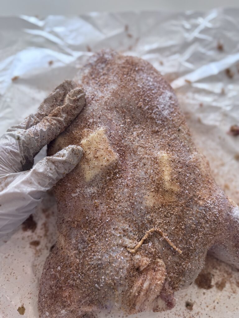 Place pats of butter between the skin and meat for a crispy skin

Rub the outside of the chicken with cajun seasoning