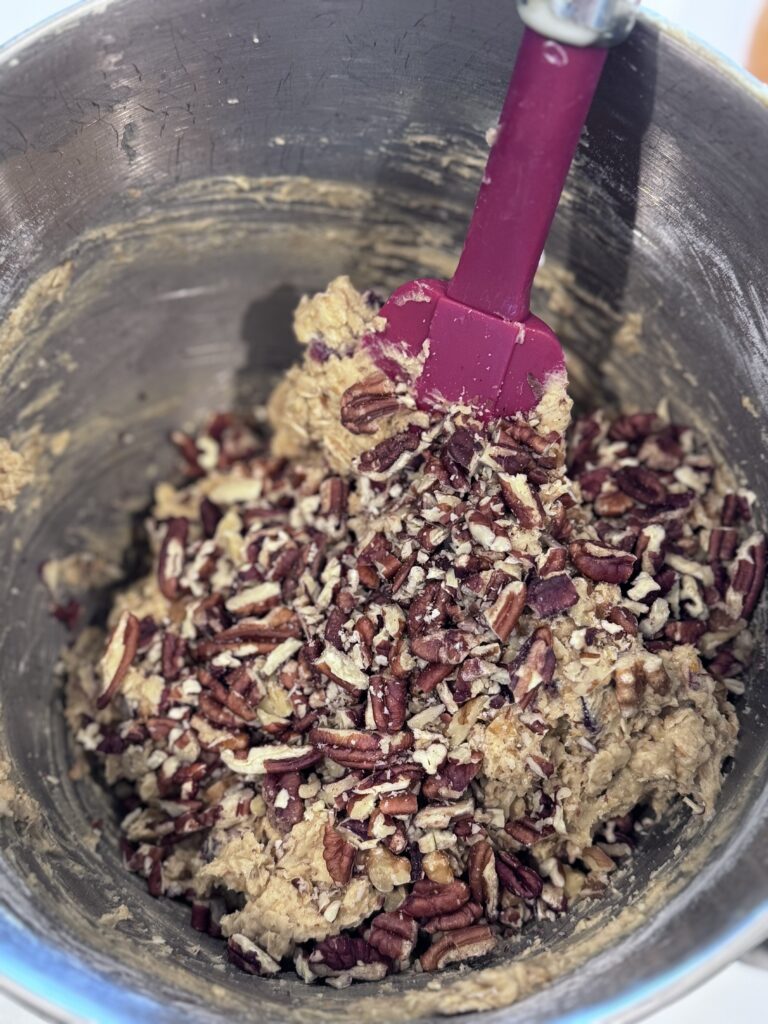 Combine Dry Ingredients: In a separate bowl, whisk together the baking soda, cinnamon, salt, and flour. Gradually add the dry mixture to the wet ingredients, beating well after each addition. Stir in the walnuts and orange rind.