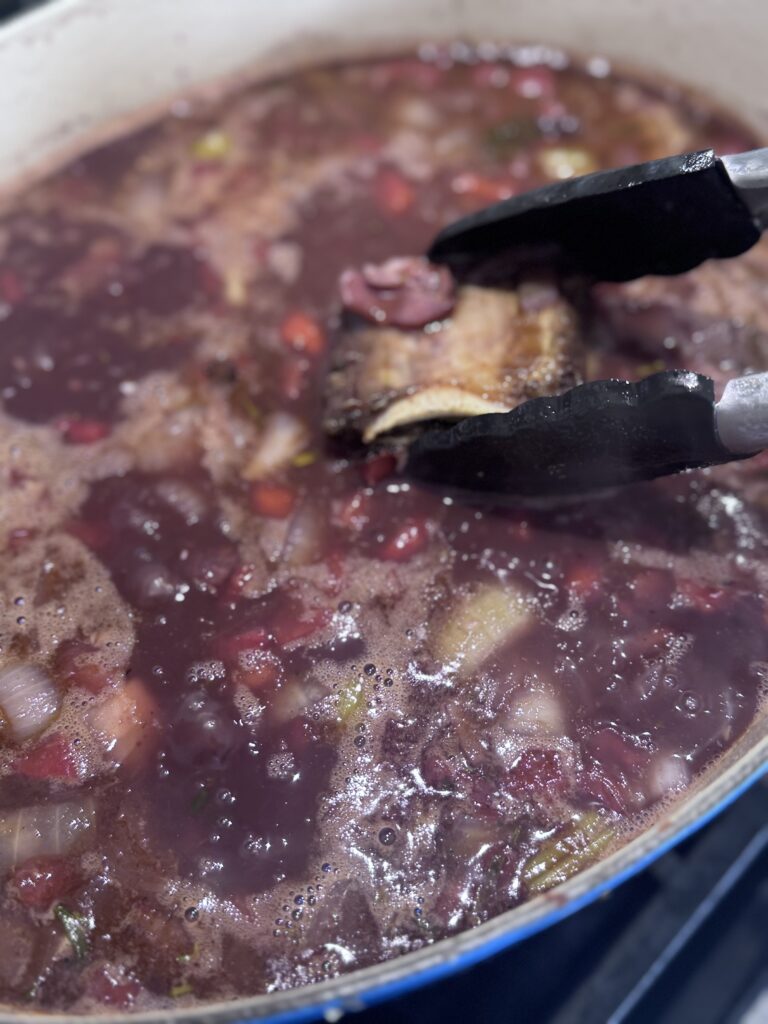 Add the short ribs, bone side up, with any accumulated juices. Cover and transfer to the oven. Cook for 2½ to 3 hours until the meat is tender and falling off the bone.