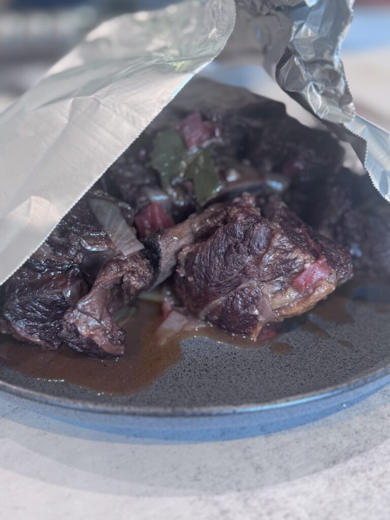 Remove ribs and tent with foil. Strain the liquid into a fat separator, discarding solids. Skim the fat and simmer the sauce until thickened, 5–10 minutes. Return ribs to the sauce and warm through.