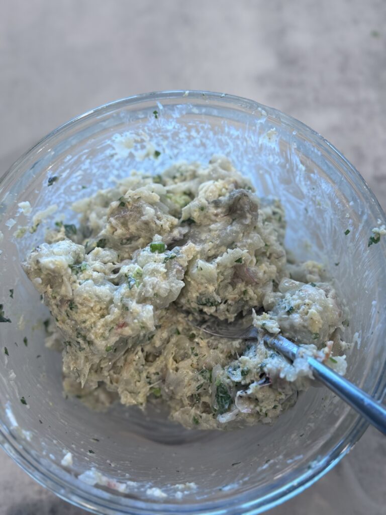 In a mixing bowl, whisk together panko, mayonnaise, scallion, parsley, lemon zest, salt, pepper, and cayenne. Fold in the processed shrimp until just combined.