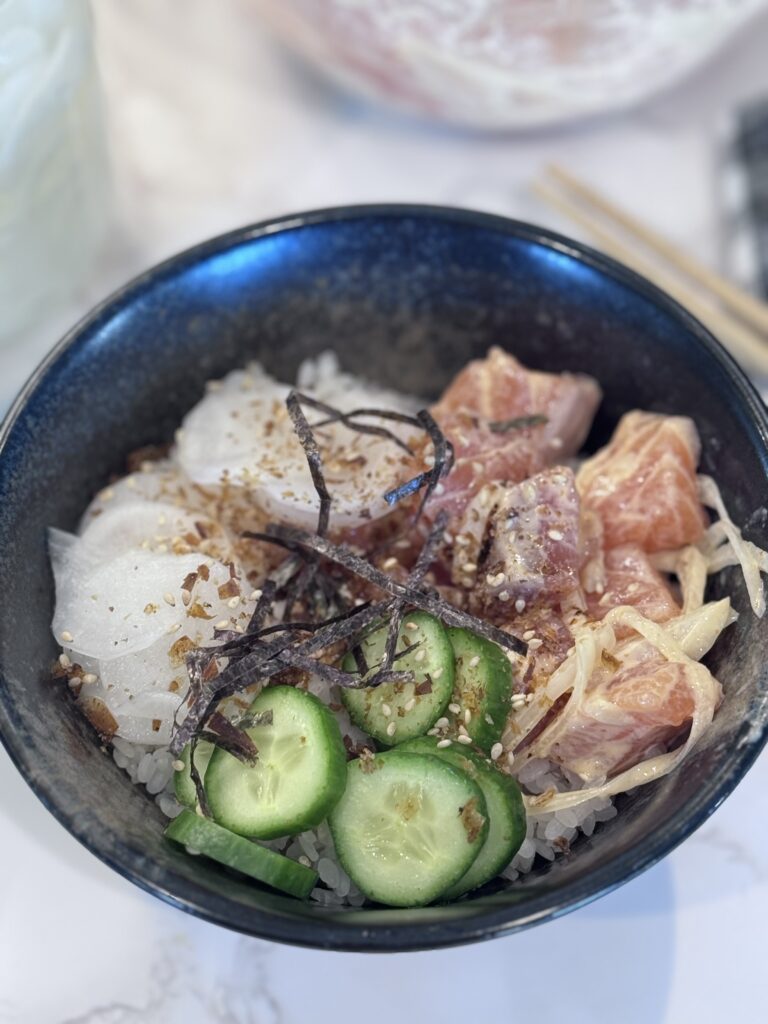  Top with the salmon mixture, pickled daikon, and scallions. Sprinkle with toasted bonito flakes. Serve immediately and enjoy!