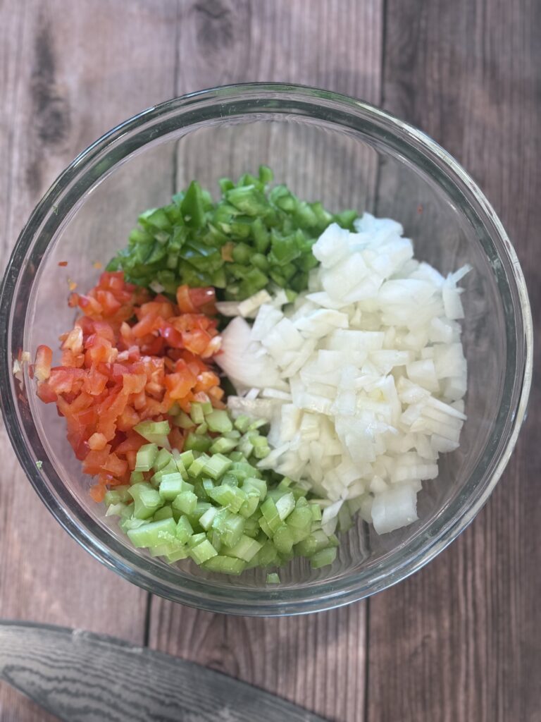 Combine the onions, bell peppers, and celery in a medium bowl. This is your “holy trinity.” Set aside.