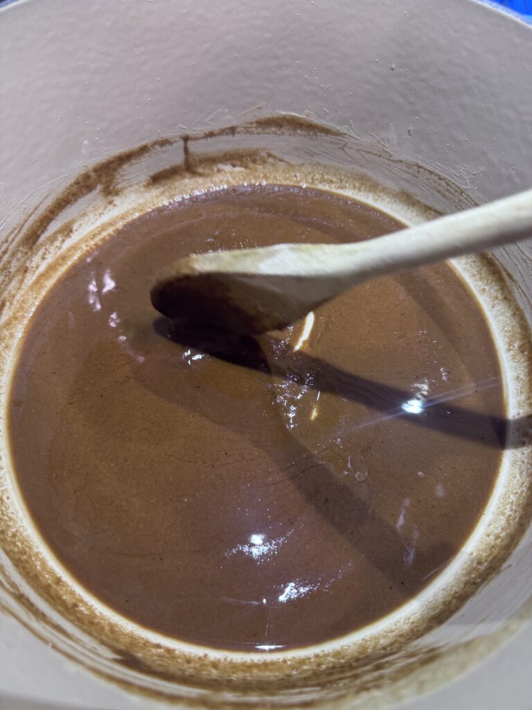 2. Cook, whisking constantly, until the roux turns dark brown (about 20-30 minutes), being careful not to let it burn.