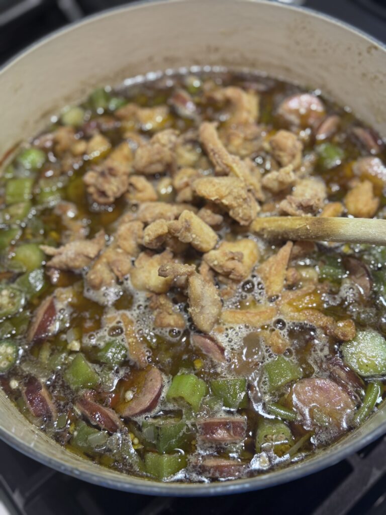 2. Add the chicken to the gumbo during the last 5-10 minutes of simmering. Adjust the seasoning with salt and pepper to taste.