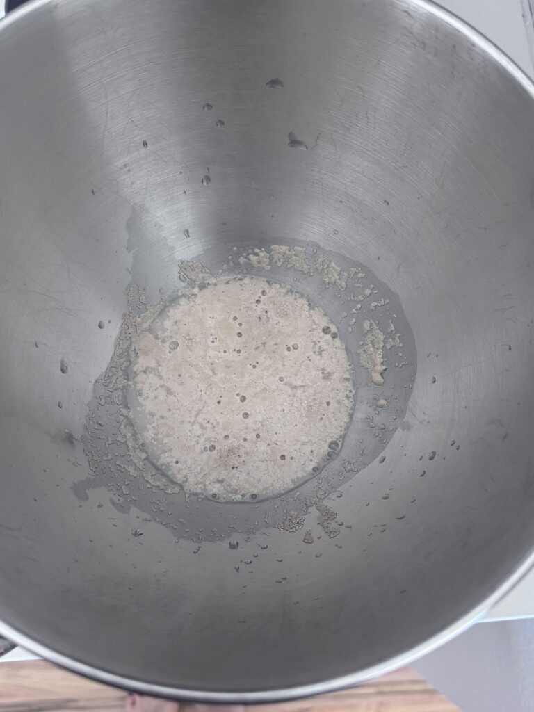 1. Activate the Yeast:

In the bowl of a stand mixer fitted with the dough hook attachment, combine 1½ teaspoons active dry yeast, ½ teaspoon sugar, and ⅓ cup warm water (105℉–110℉). Let it stand for about 7 minutes until the mixture becomes foamy.