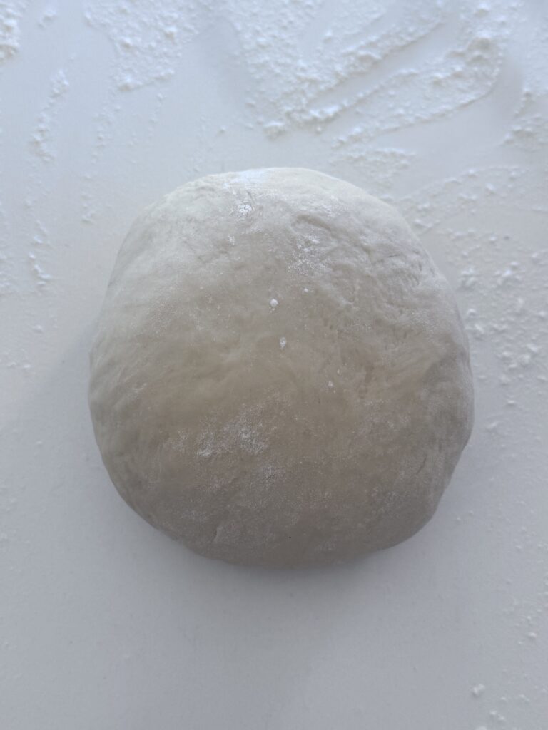 4. Knead and Proof the Dough:

Scrape the dough onto a lightly floured surface and knead it gently 4–5 times. Transfer the dough to a greased bowl, turning it to coat the top. Cover with plastic wrap and let it stand in a warm, draft-free place (about 75℉) for 1 hour and 15 minutes, or until doubled in size.