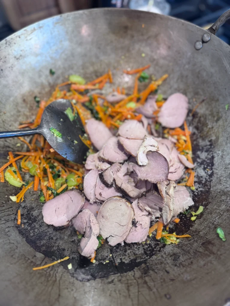 Add pork and greens