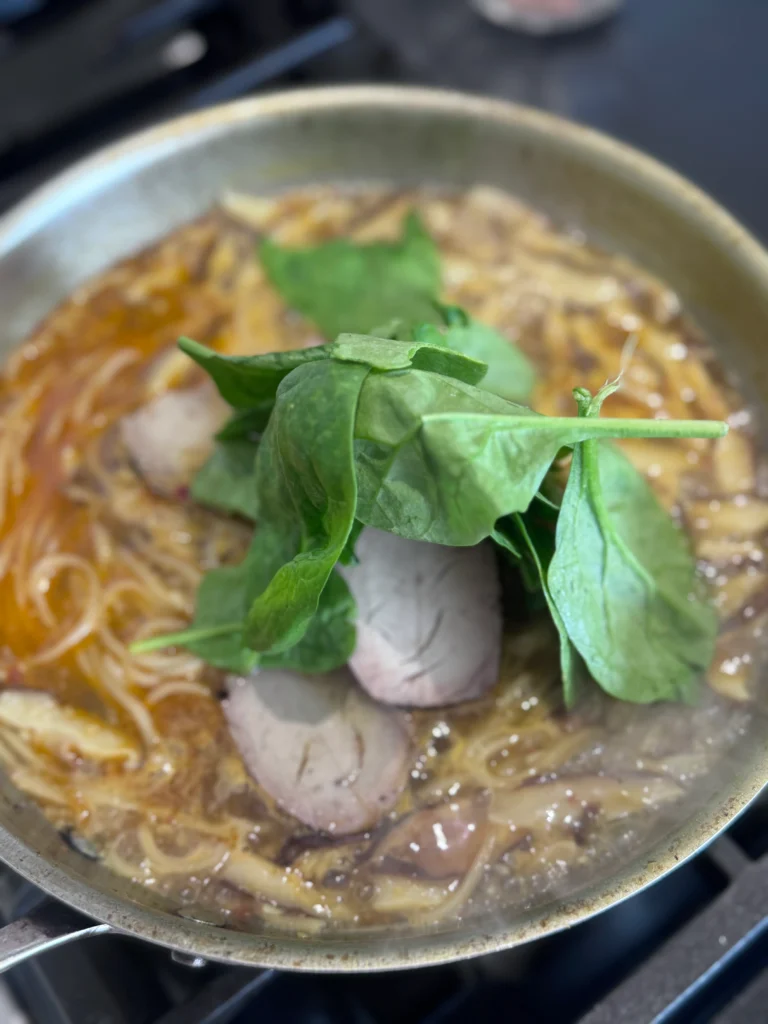 Add the pork and spinach