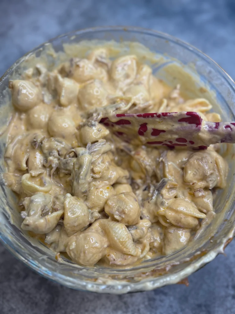 combine the pasta, cheese sauce, and pulled pork